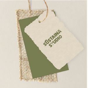 Sustaina Studio logo featuring nature-inspired imagery within the text, printed on a recycled-material tag with a natural texture and earthy tones.