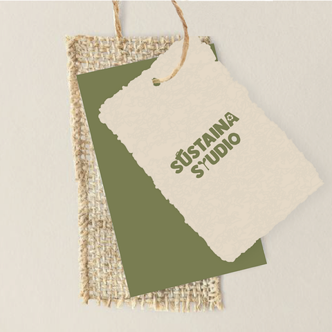 Sustaina Studio sustainable brand identity shown on packaging tag with natural textures and organic color palette