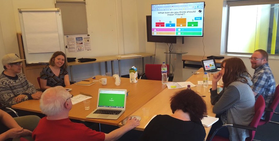 Room of people doing a digital questionnaire