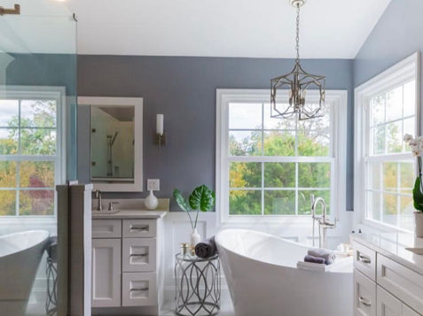 Modern bathroom with a white tub and natural light Manning Building Company