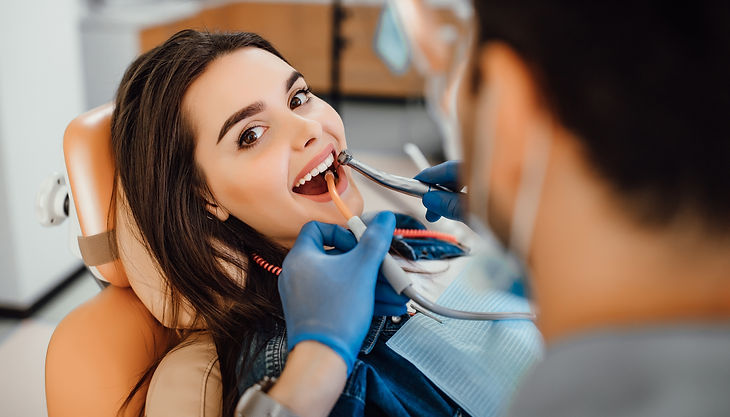 young-female-patient-visiting-dentist-office.jpg