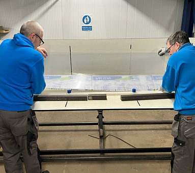 Two workers Bending Plastic