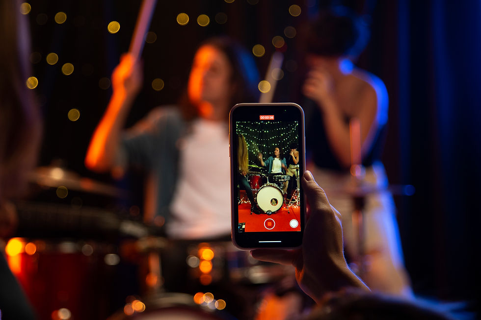 close-up-hand-holding-smartphone-concert.jpg