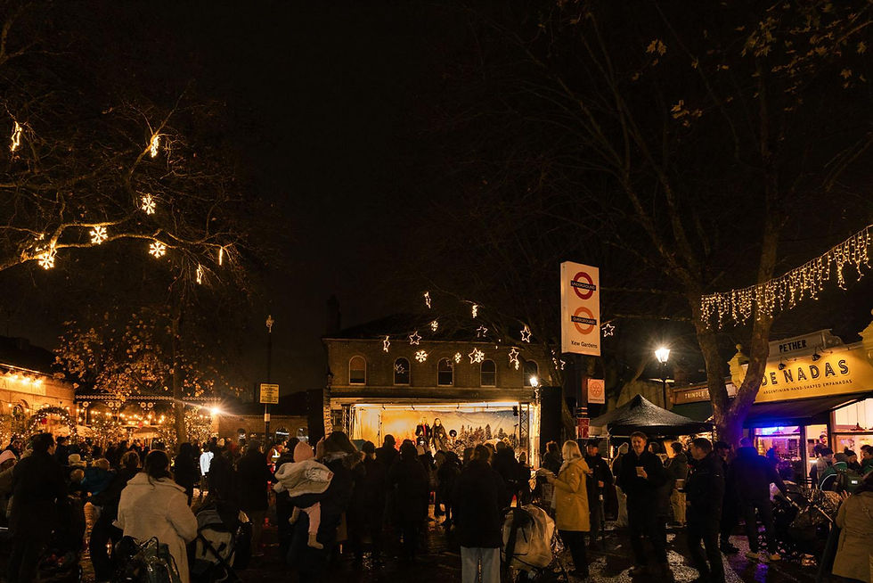 Crowd gathered at a night market with Christmas lights