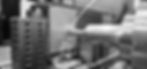 A dark and blurry background image of a CNC machine setup at Rays workplace.