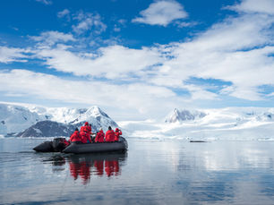 Inflatable boat full of tourists, watching for whales and seals Antarctic Peninsula, Antarctica