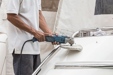 Man buffing a boat using a machine