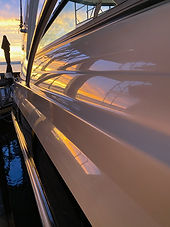 Cabin boat polished to a mirror finish reflecting the sunset