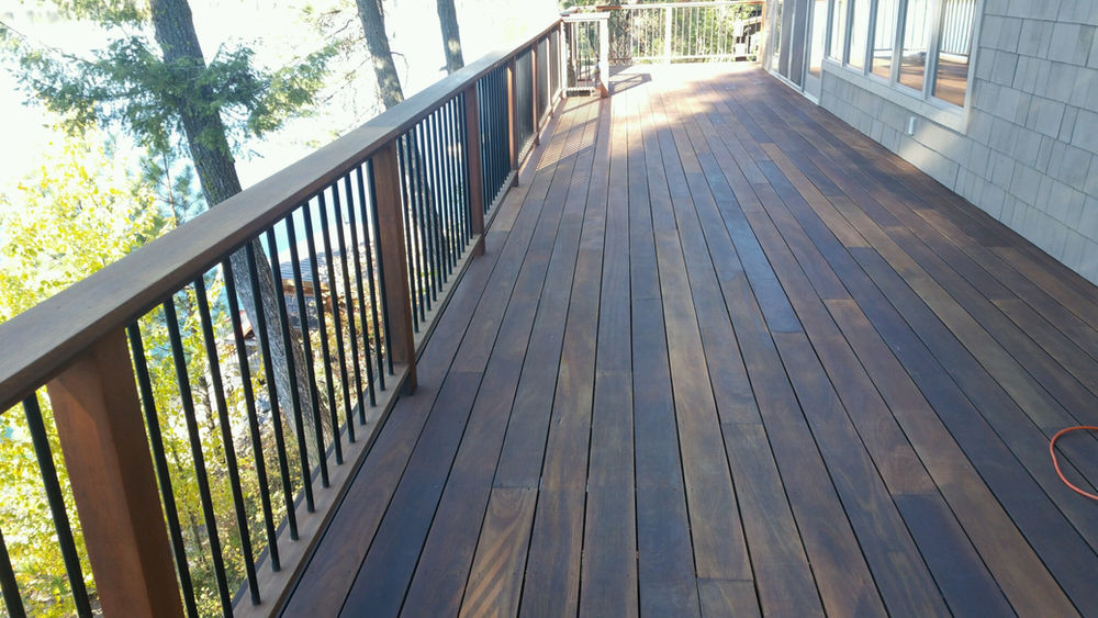 Balcony deck surrounded by trees stained by best Miami wood finishing contractor.