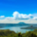 vibrant sunny day in taal lake with taal volcano erupting.jpg