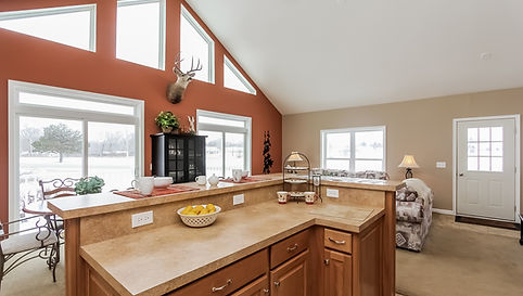 cozy, rustic-style kitchen and living area with large windows