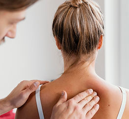 male-osteopathic-therapist-checking-female-patient-s-spine.jpg