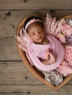 Newborn baby peacefully sleeping, wrapped in soft fabric