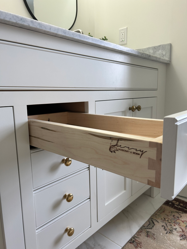 Maple dovetailed drawers in custom handcrafted solid wood vanity with beaded accents