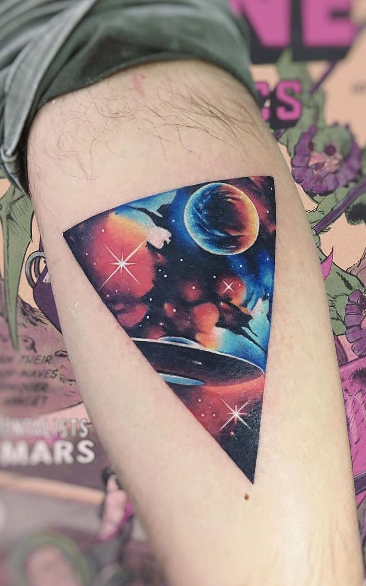 bright colors moon and space tattoo on mans thigh
