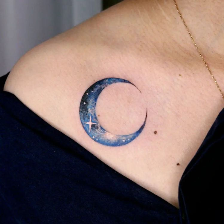 sparkling color moon and stars tattoo on womans chest under collarbone