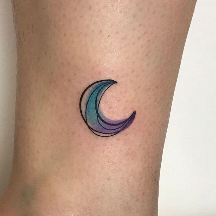 beautiful moon watercolor tattoo on womans ditch of the arm