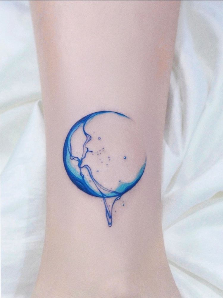 unique moon and wave watercolor tattoo on womanswrist