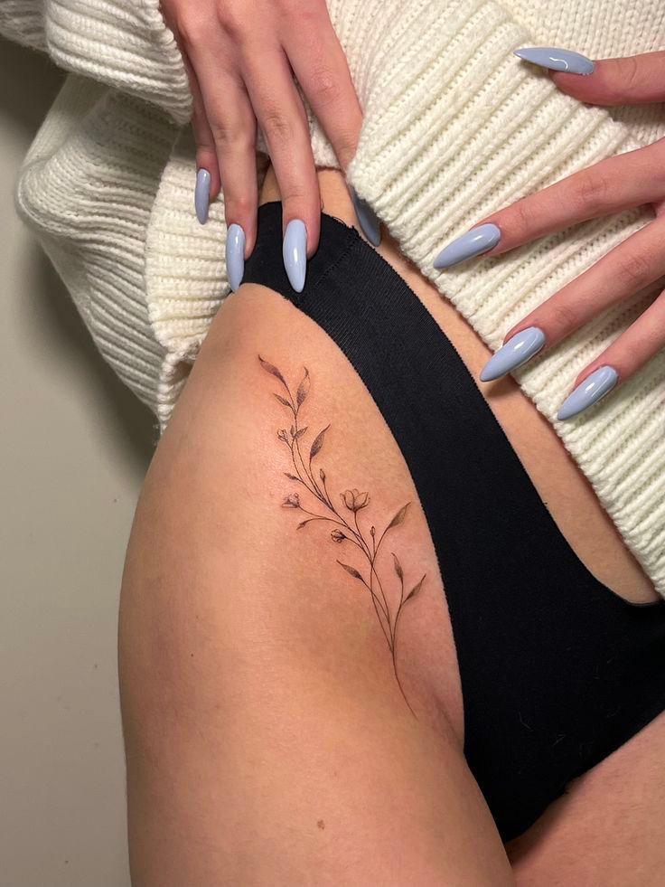 Delicate Fine Line tiny bouquet botanical floral flower tattoo on woman’s hip