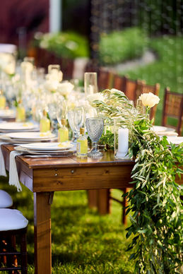 Elegant tented wedding reception with gold chiavari chairs, romantic blush floral arrangements, and a champagne seating display. Luxury wedding planning and décor styling by Pop and Props in Chicago.
