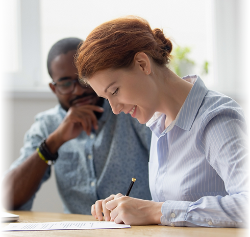 Borrower signing documents with broker support—illustrating a successful loan process facilitated by a lending partner