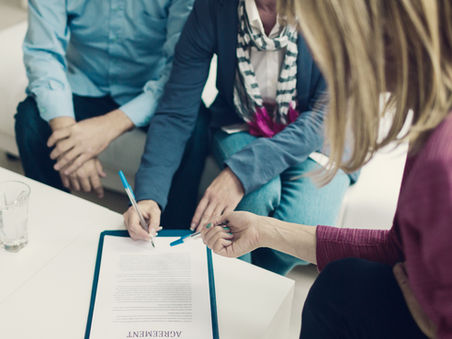 Group of people preparing to sign an insurance contract.