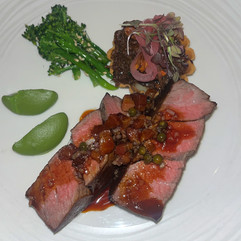 A medium-rare fillet of beef served with broccoli and other accompaniments
