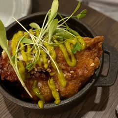 A bowl of sticky glazed crispy chicken bites
