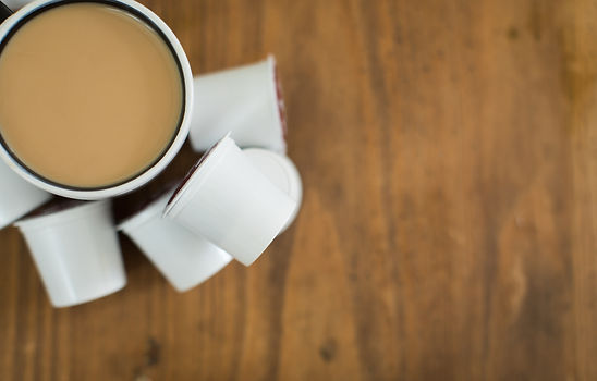 Coffee cup sitting on a table. Top View