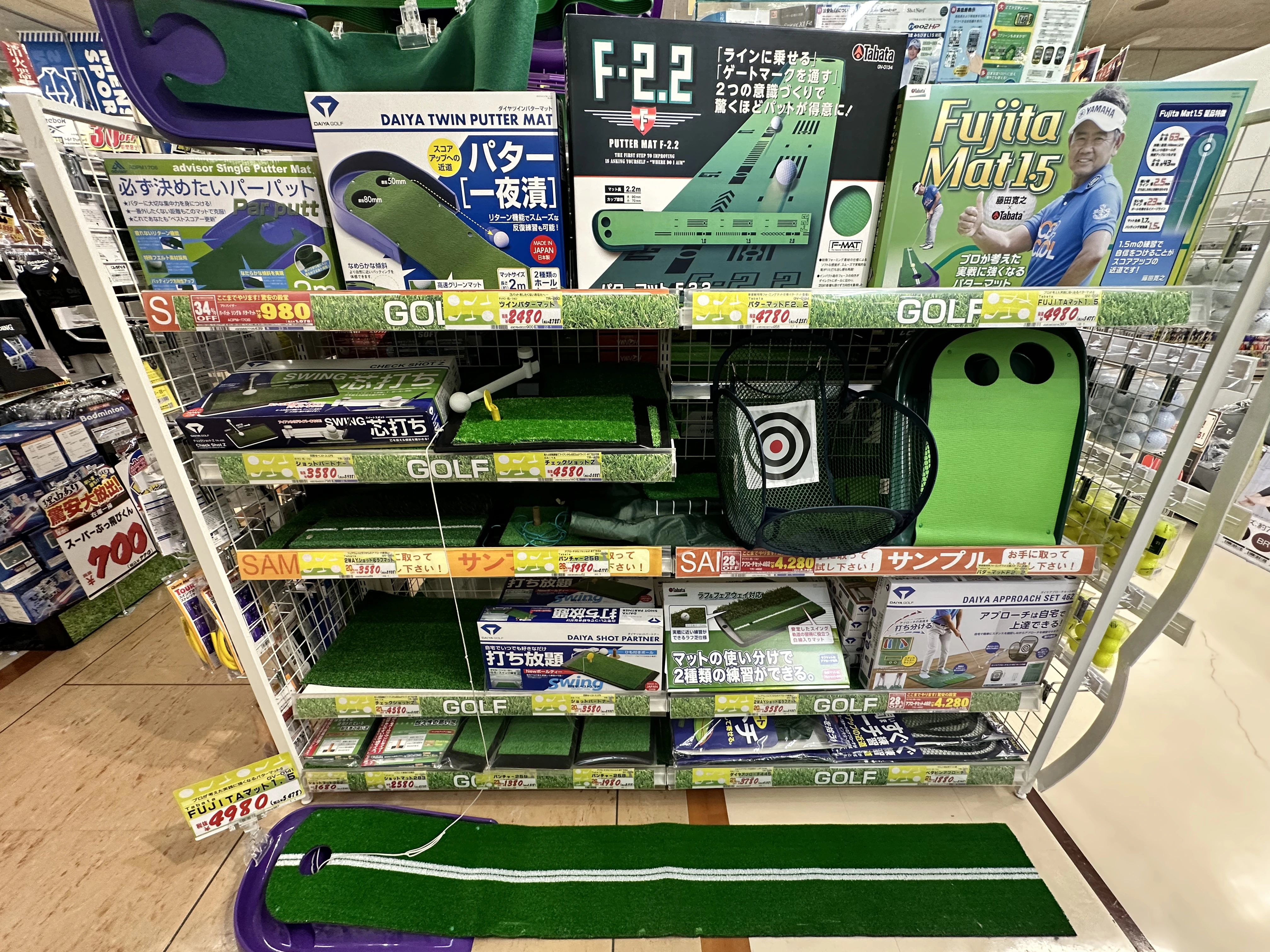 Golf practice mats and training accessories displayed in a Japanese store, showing hobby and sports items that may be available tax free for tourists in Japan
