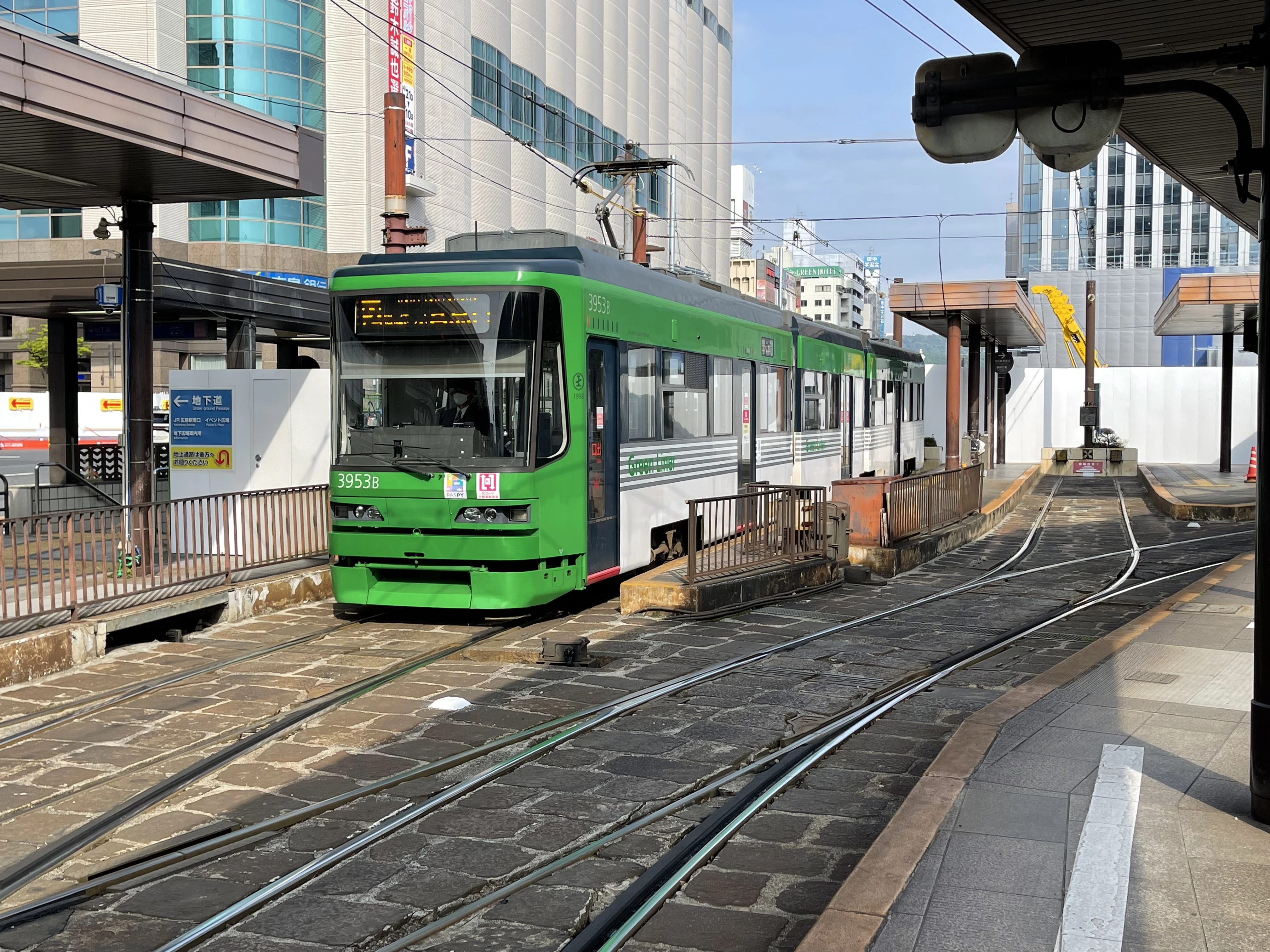 City tram in Japan at an urban station, showing everyday public transportation commonly paid with IC cards or cash