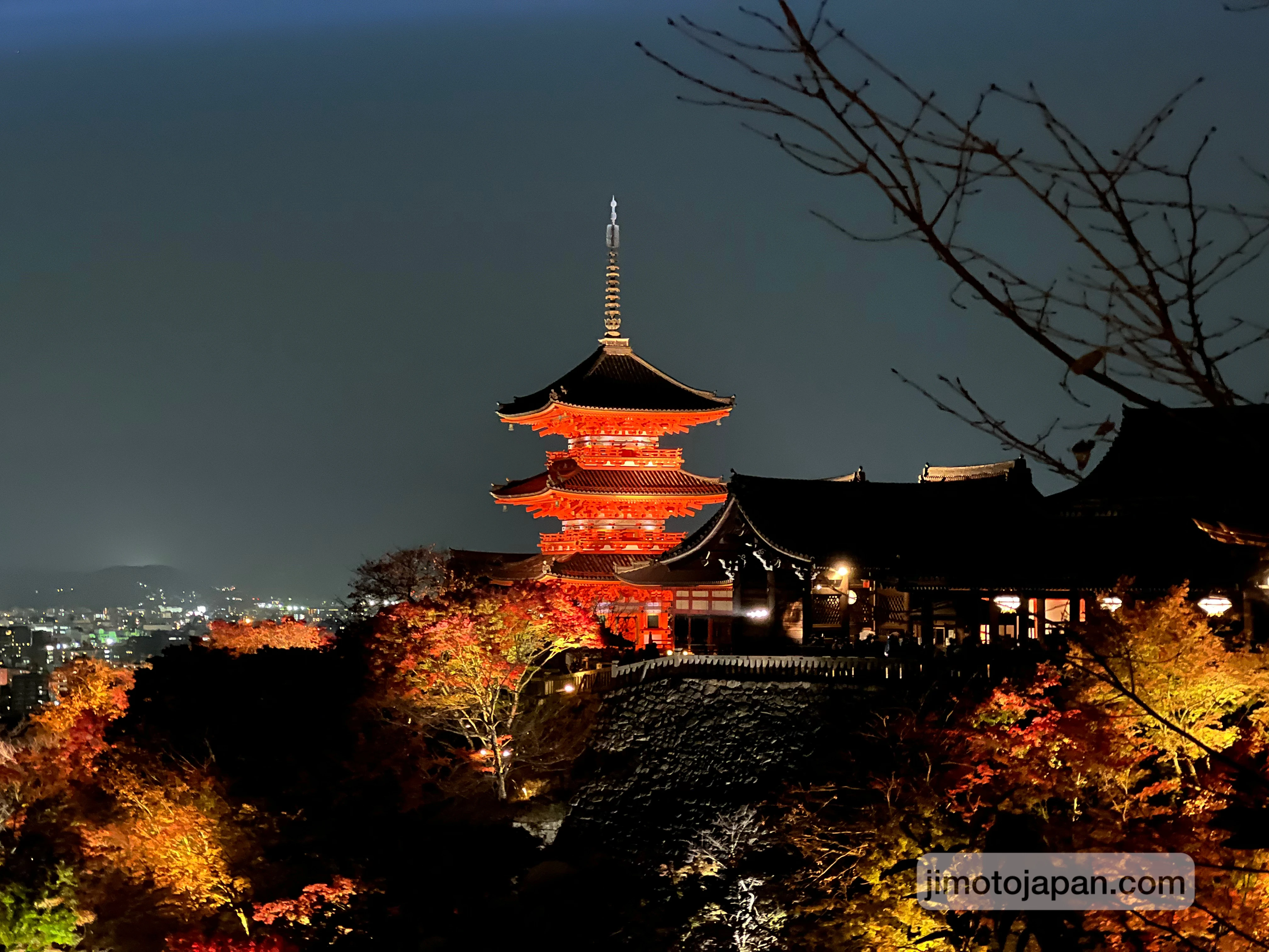 Illuminated Japanese temple and pagoda at night, showing cultural attractions that are free or low cost