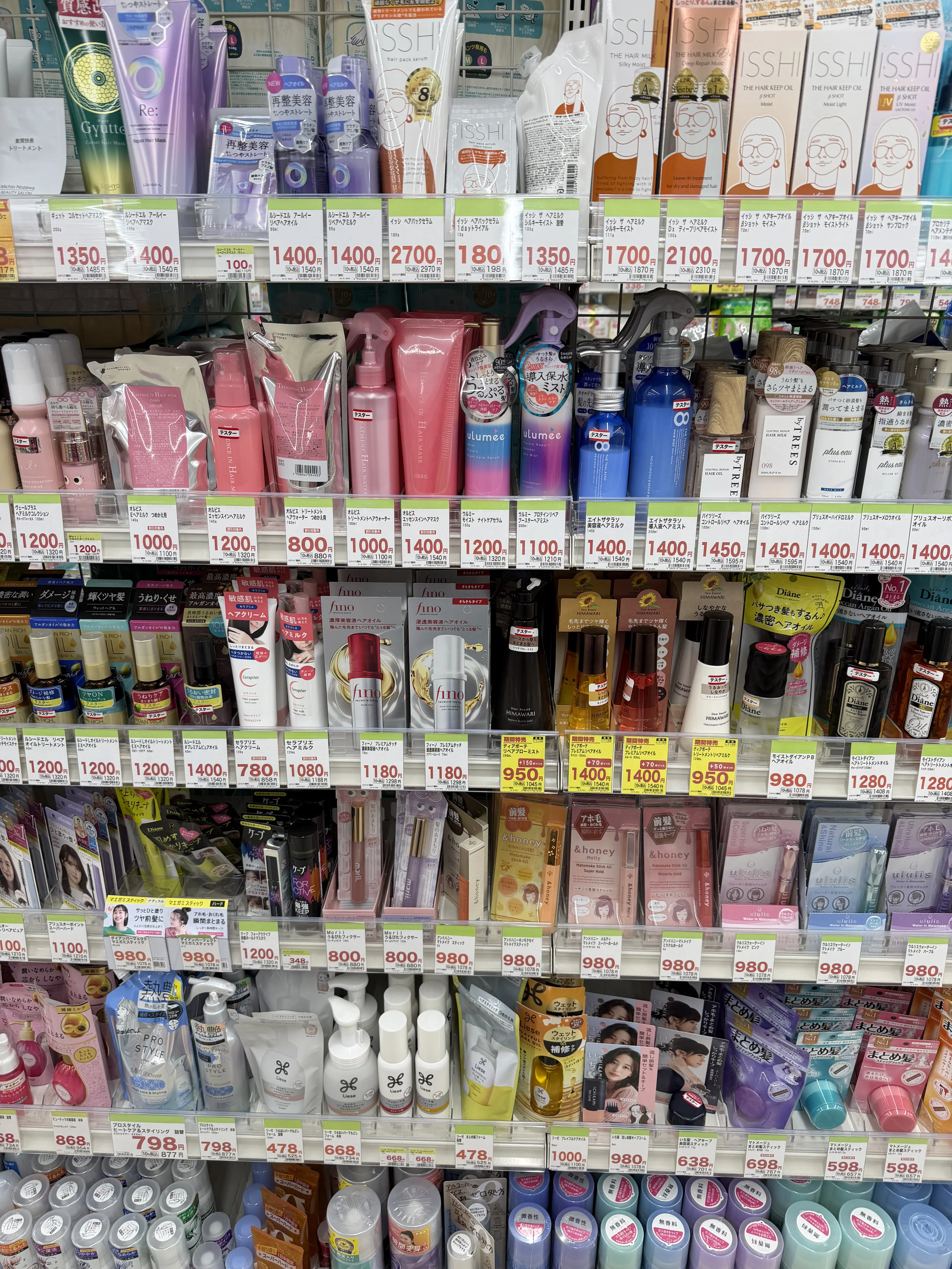 Japanese haircare and beauty products displayed on store shelves, showing popular shampoos, treatments, and styling items often available tax free for tourists in Japan