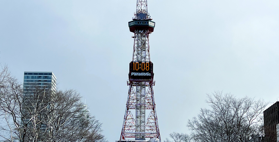 Sapporo TV Tower at daytime. Odori Park at daytime with snow.