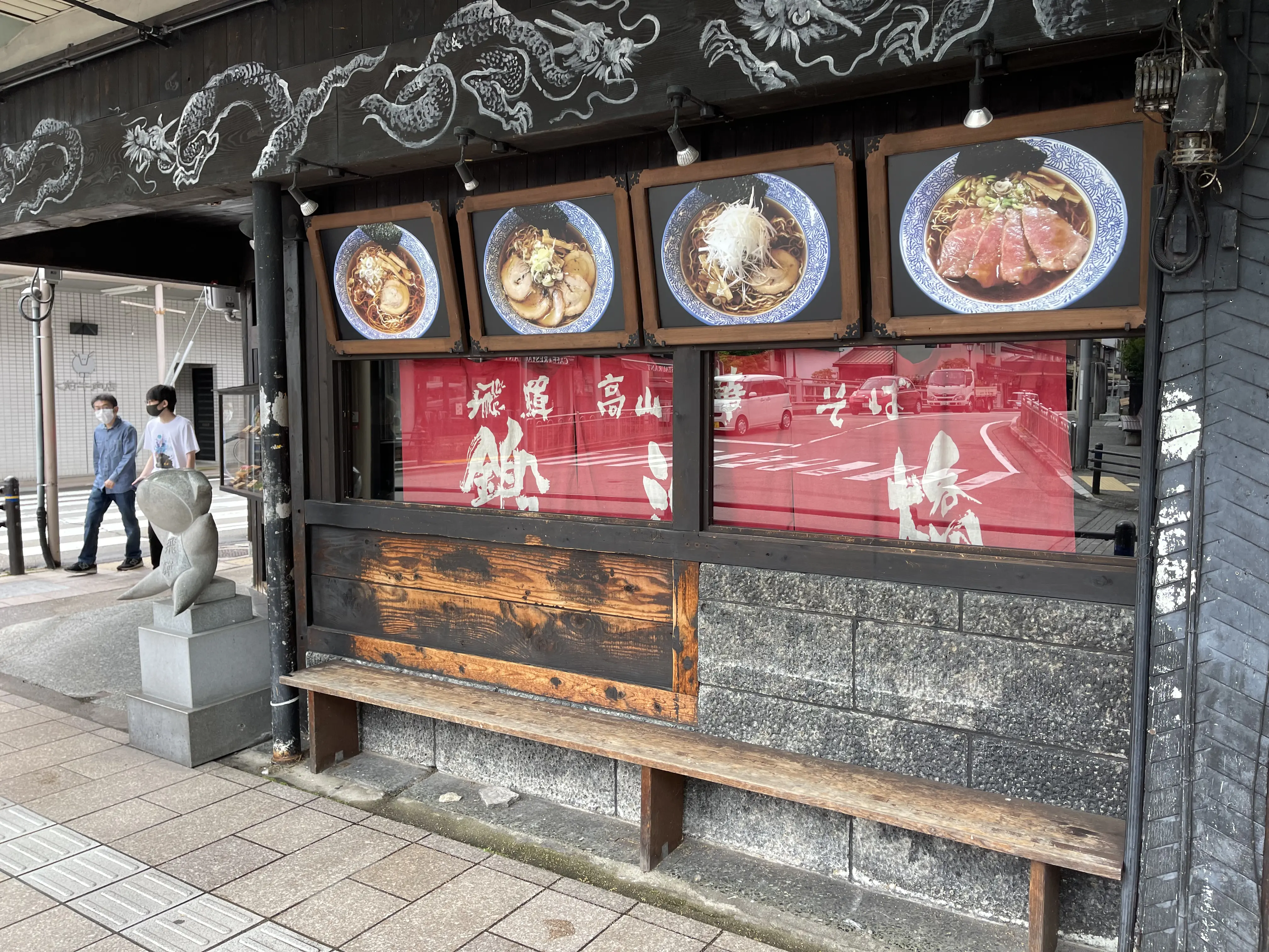 Local ramen restaurant in Japan with food photos on the menu, showing an affordable eatery where cash payment is common