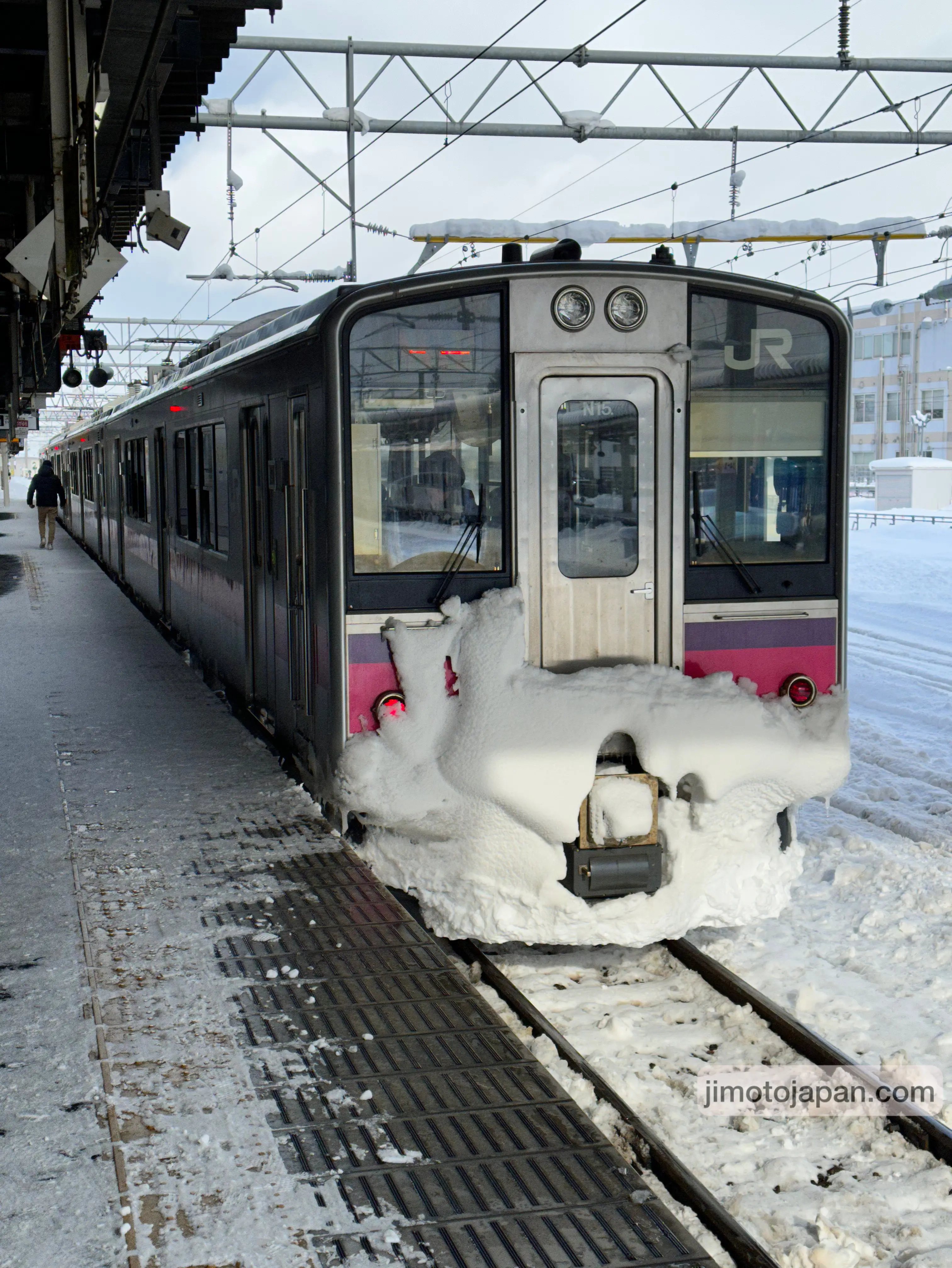 Japanese regional train in snowy conditions, demonstrating reliable public transportation in winter