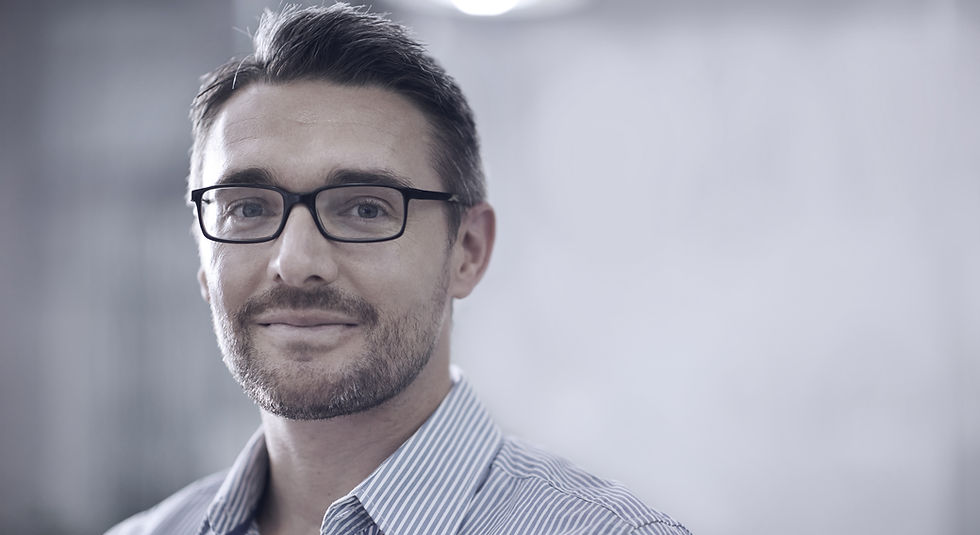 Business owner with glasses looking into camera