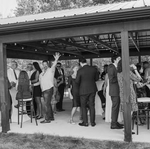 guests under the pavilion at barn wedding venues near me