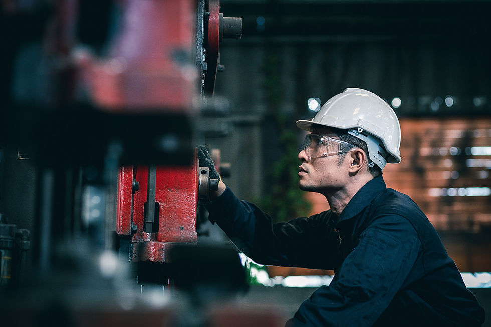 Engineer operating equipment in industrial setting supporting infrastructure and system reliability