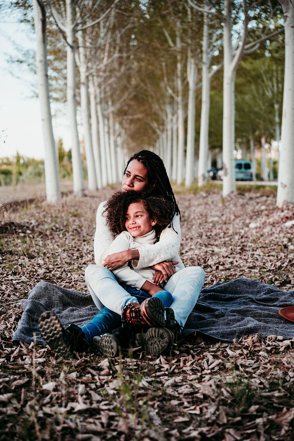 full-length-mother-with-daughter-sitting-park.jpg