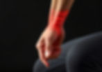 A hand clutches a wrist with red glowing lines indicating pain, set against a dark background. The mood suggests discomfort.