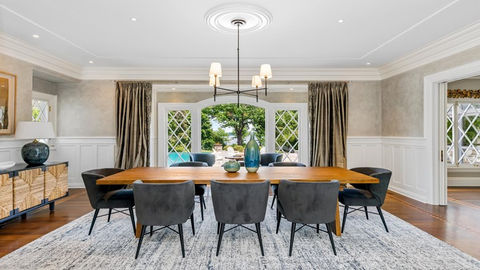 Elegant dining room with large wooden table, chairs, and KLI New design.