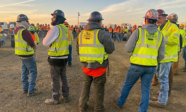Construction workers in hard hats and high-vis vests