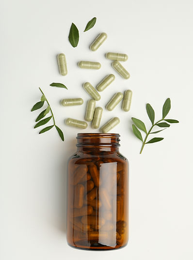herb-capsules-flowing-from-a-bottle-with-leaves