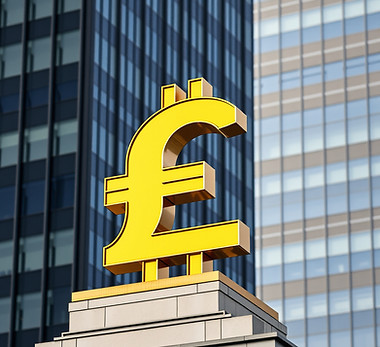 golden pound sign on top of a building .jpg