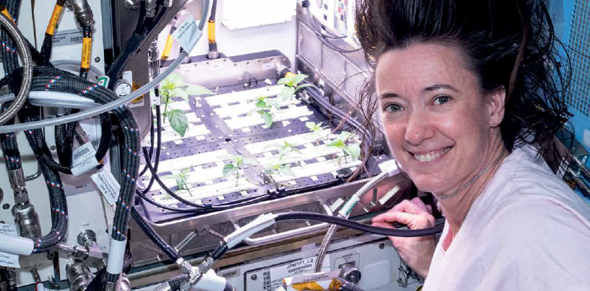 Astronaut Posing For the Camera and Growing Vegetables in Space