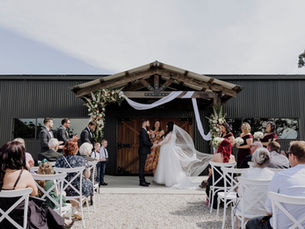Wide shot of Leonards Hill Estate’s lush gardens and rolling hills, ideal for country weddings near Melbourne Beautifully decorated wedding reception inside Leonards Hill Estate’s Pavilion with festoon lighting and natural timber features Bride and groom walking hand-in-hand through the estate’s garden pathway surrounded by native Australian flora Custom-built bar at Leonards Hill Estate ready for wedding guests, featuring premium glassware and rustic styling Couple enjoying a relaxed moment during their wedding day at Leonards Hill Estate, a country wedding venue 80 minutes from Melbourne