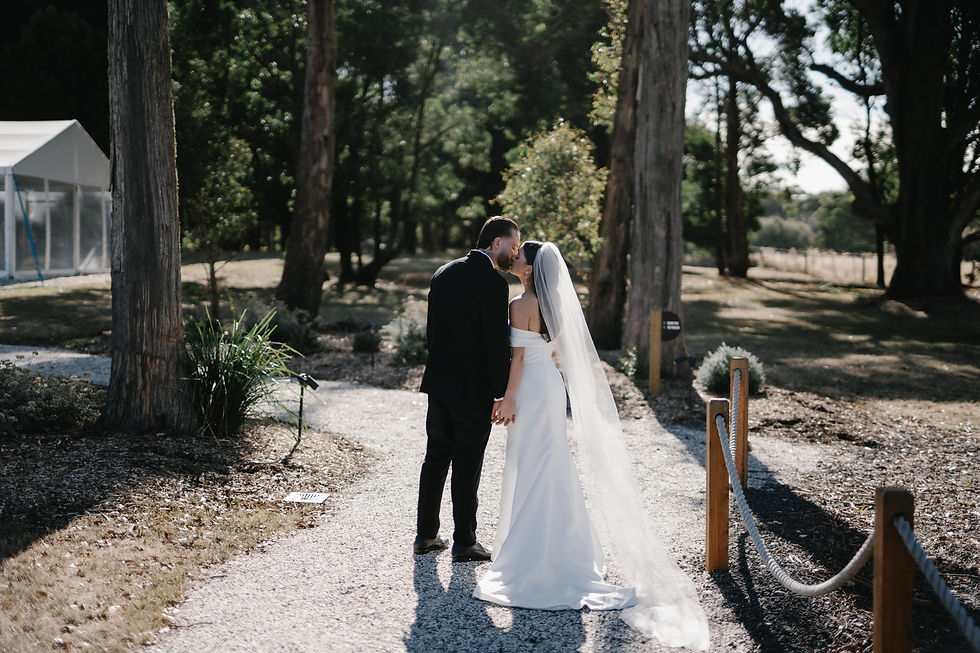 Bride and groom walking in the gardens at Leonards Hill Estate Daylesford wedding venue