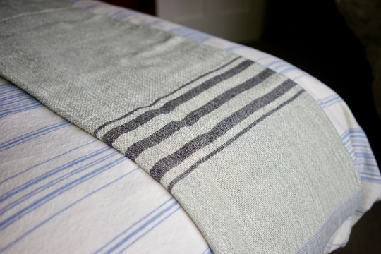 Thumbnail: Handwoven Luxury Wool Blanket Draped Laid Out on Bedding