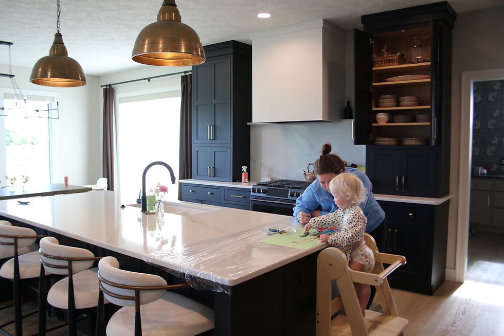 Rachel and her daughter painting pictures on the kitchen counter in an organized area
